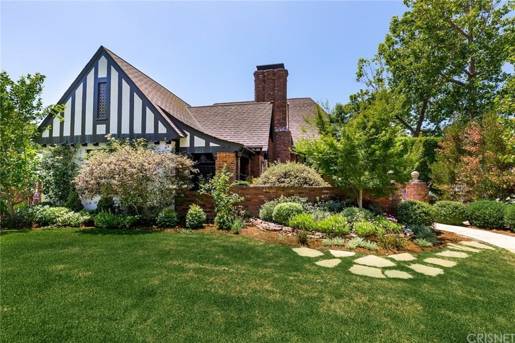 Tudor style home sits amongst its gardens on corner lot in Los Angeles