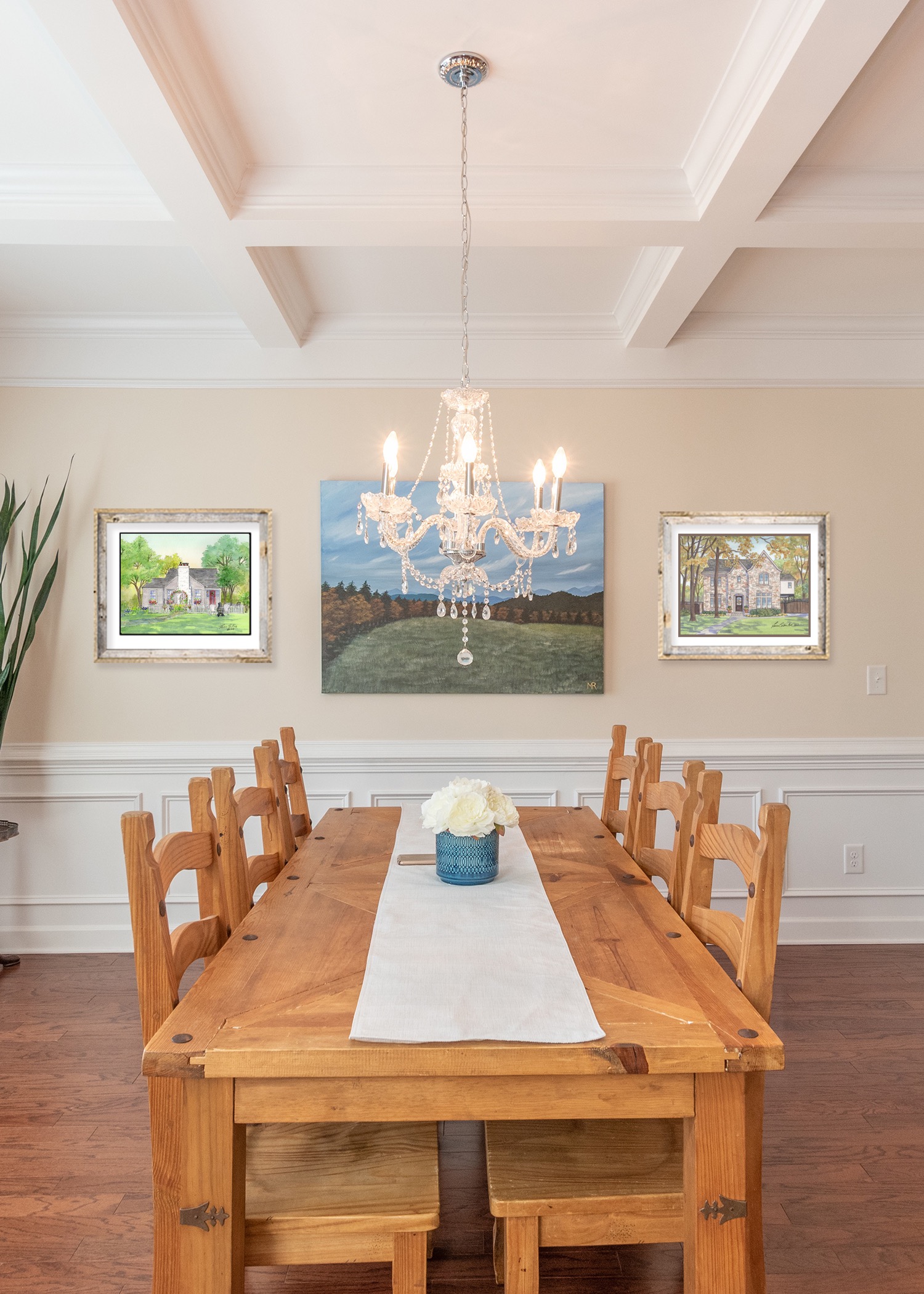 A pair of house potraits grace this dining room setting. 