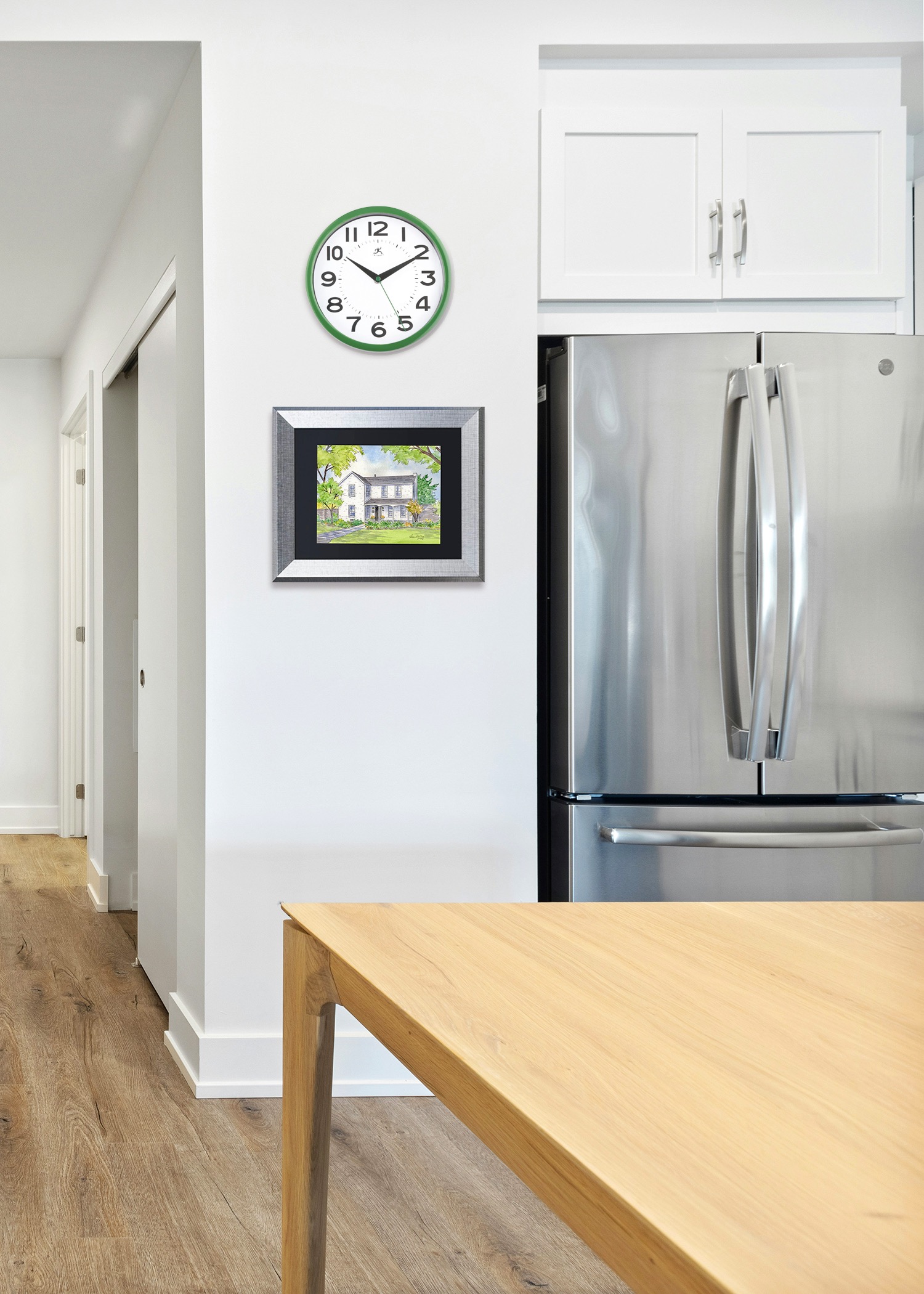 A house portrait placed by the fridge is sure to be seen. The matching frame sets it off.